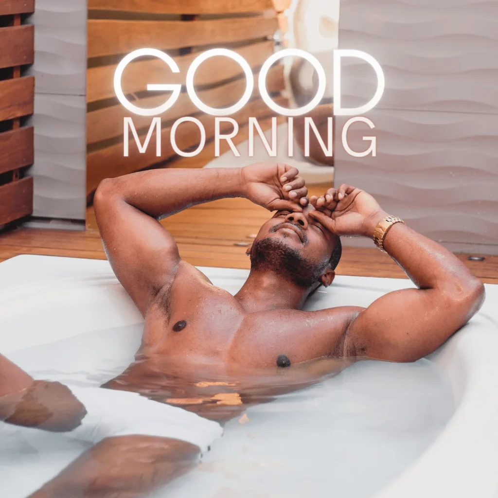 A black man submerged in the bath tub early in the morning.png