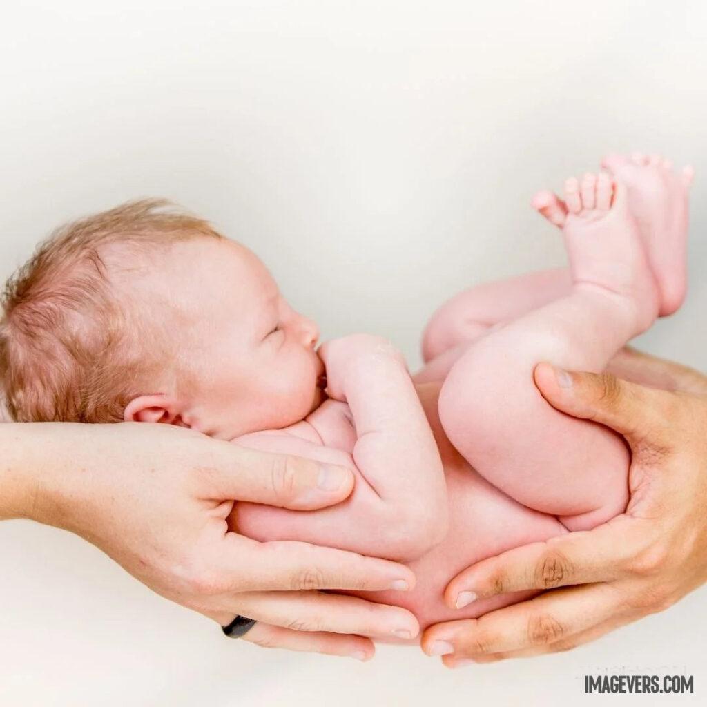 A newborn baby is sleeping on all four hands with both his legs up and right hand on his mouth.jpg 1 11zon