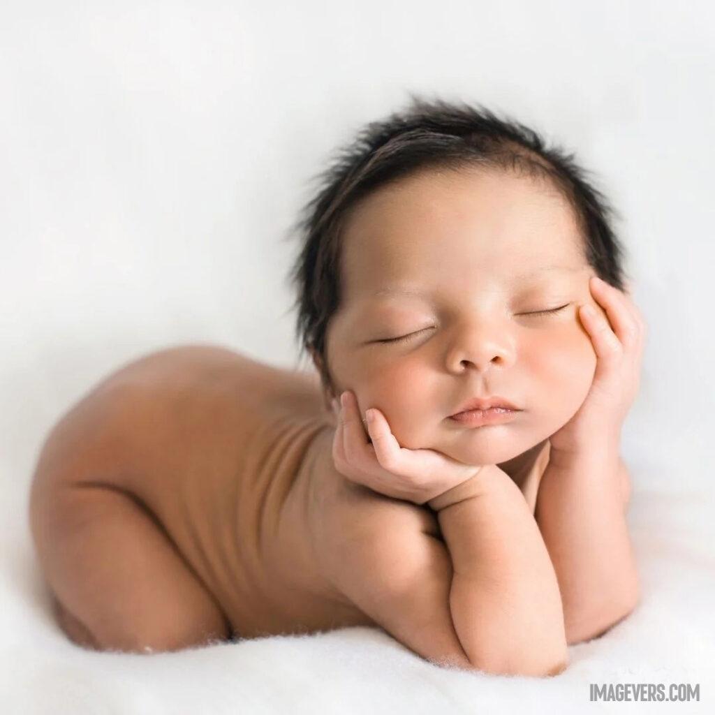 A newborn baby is sleeping on the weight of the stomach with both hands on the neck on the white blanket.jpg 8 11zon
