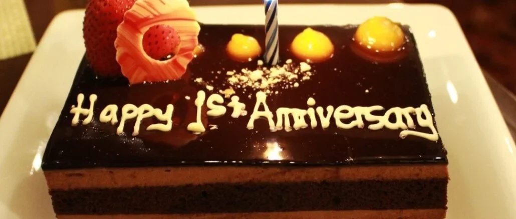 First-anniversary-cake-along-with-a-candle-is-decorated-with-fresh-strawberry-with-dark-chocolate