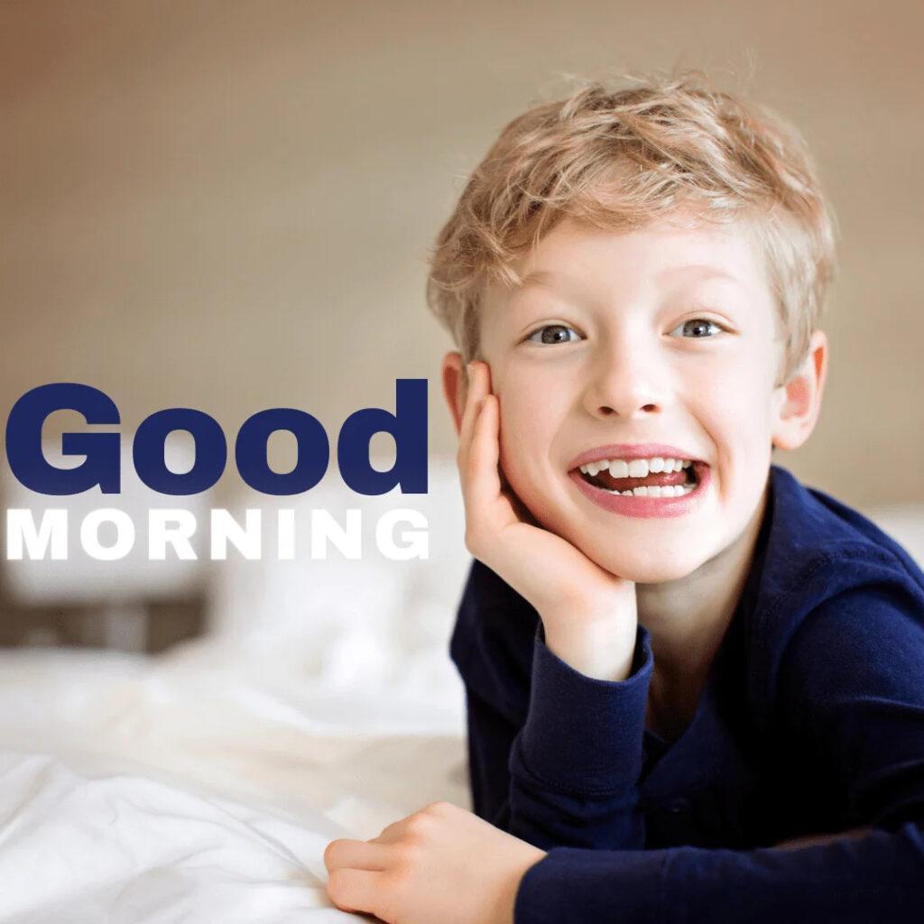 Kid smiling in bed in morning.png