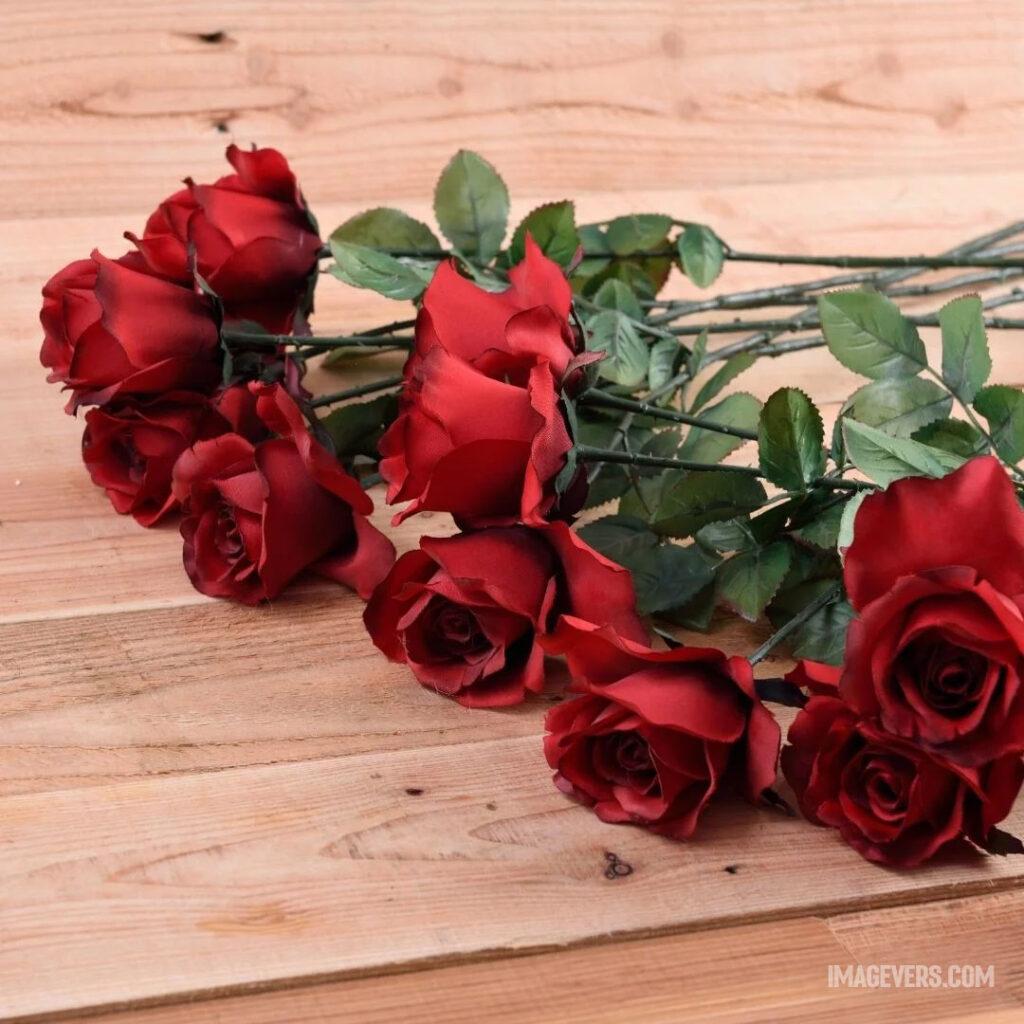 The-vibrant-red-color-of-these-roses-are-placed-on-a-wooden-table-makes-incredibly-beautiful-sight