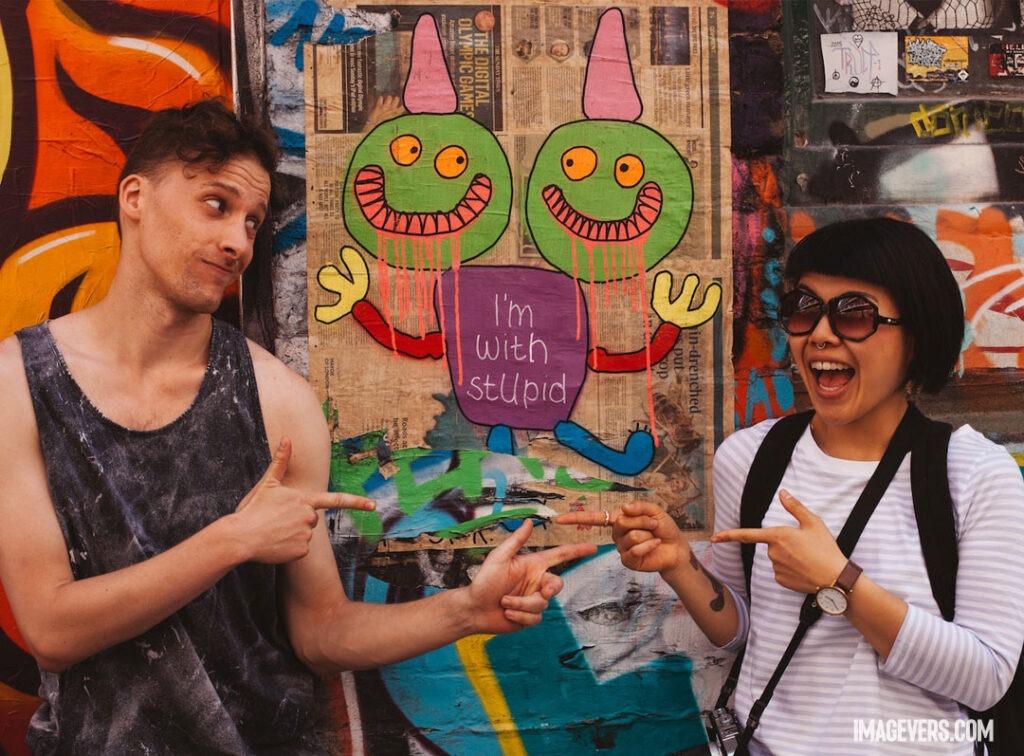 Man-on-Black-Tank-Top-Pointing-at-Woman-on-White-Long-Sleeve-Top