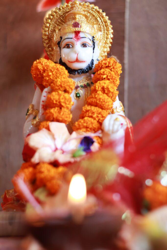 Orange Garland on a Hindu God Statue-min