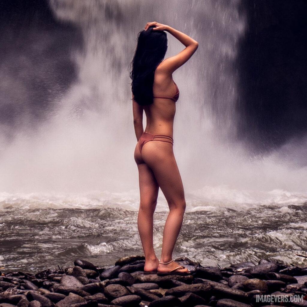 Photo-of-a-Woman-Wearing-Bikini-in-Front-of-Waterfalls